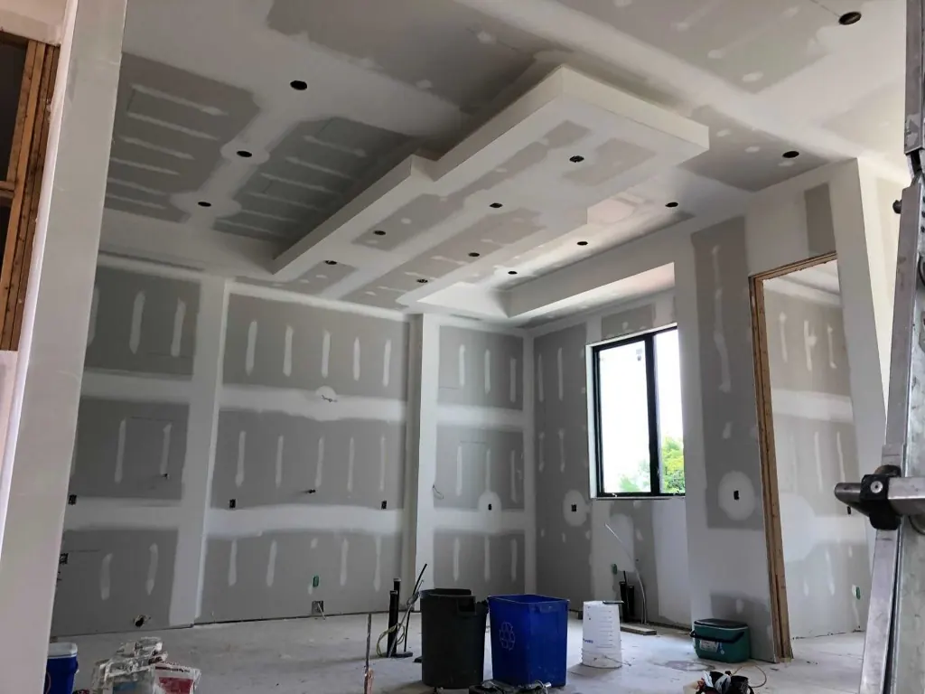 Drywall hung and taped in a room KM Contracting opened up